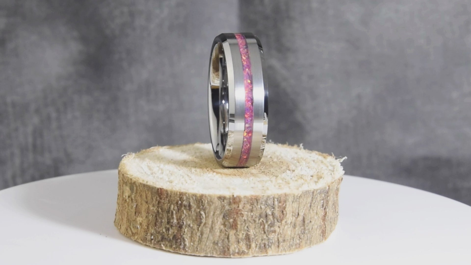 Tungsten Pink Fuchsia Opal Center Line Ring Spinning on Wood